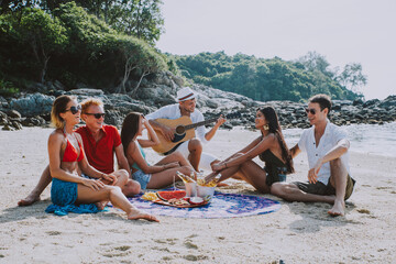 Group of friends having fun on the beach on a lonely island