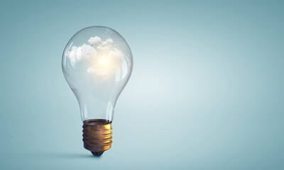 Light bulb on light blue background