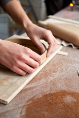 Female ceramist working in pottery studio. Ceramist's Hands Dirty Of Clay. Process of creating pottery. Master ceramist works in her studio