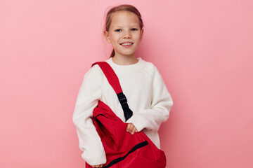 little girl with a red backpack fun isolated background