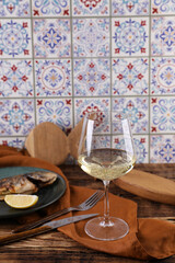 Grilled fish and wine on a wooden table