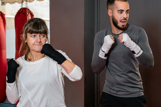 Mature Woman At The Gym In Boxing Class With Her Teacher