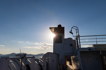 Fireplace and life raft on the ferry to the island of Elba in Tuscany in the backlight