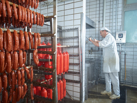 Butcher washing machinery with water in factory