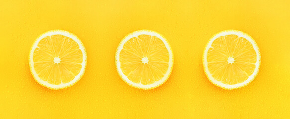 lemon on a yellow background with drops of monochrome