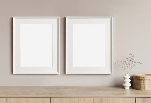 Two blank picture frames mockup on white wall. Templates for painting or poster. Living room interior design. View of modern rustic style interior with artwork mock-ups