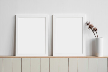 Two blank picture frames mockup on white wall. Templates for painting or poster. Living room...