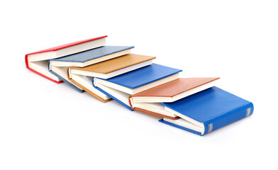Stack of red, blue, yellow and brown books isolated on a white background