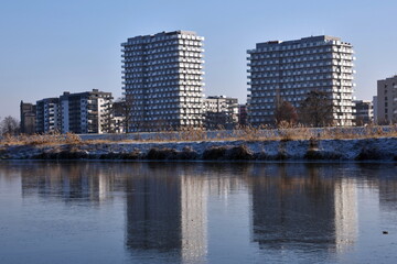 Modern residential buildings in Wroclaw, Poland with frozen Odra river.