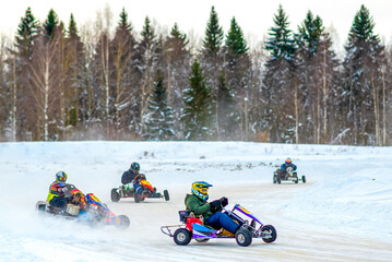 Adult ride a racing cart on the track in winter. Karting school for adults, training men to drive a car. Driving school. - obrazy, fototapety, plakaty