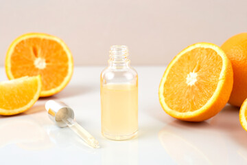 Pipette with orange essential oil over bottle and oranges. Natural medicine concept. Aromatherapy