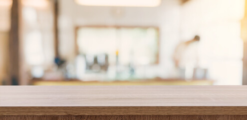 Wooden table top with blurred people in coffee shop and cafe background for display montage, copy space.