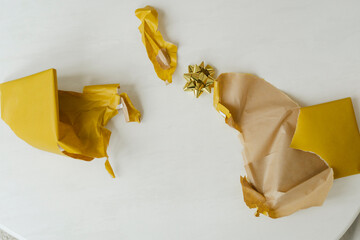 Torn gift wrapping paper on table