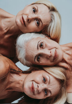 Cincematic image of a beautiful senior woman posing on a beauty photo session. Middle aged woman in lingerie on a grey background. Concept about body positivity, self esteem, and body acceptance