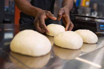 African chef preparing food for baking at the kitchen
