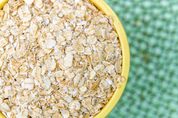 Raw oatmeal in small yellow container