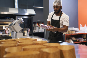 Male in protective clothes working at the kitchen