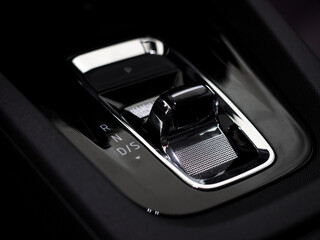 Fototapeta na wymiar modern automatic gearbox gear selector. stylish car interior dark with chrome