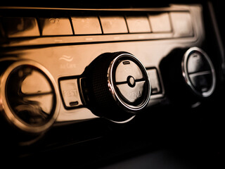 car control panel buttons and climate inside a new modern car. stove and air conditioning, climate...