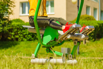 Girl doing legs exercise at outdoor gym area
