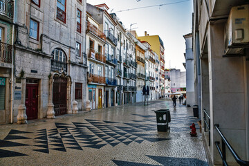 Fototapeta premium Narrow street local Shops in Alfama Lisboa district. Lisbon, Portugal