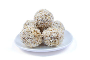 Original Thai popped rice (Khao Tok Tang) is traditional Thai desserts in white plate isolated on white background included clipping path.