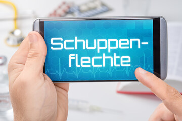 Smartphone mit dem Text Schuppenflechte auf dem Display