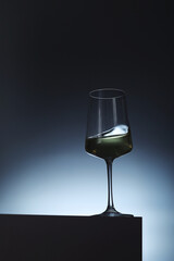 White wine in a transparent glass in low key