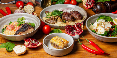 Traditional Georgian cuisine dishes on the table. Side view. Flat lay. A lot of spices and vegetables around