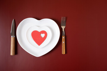 Heart form white plate on red background