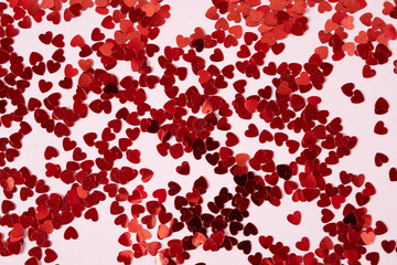 Pink background with glitter hearts for valentine's day.