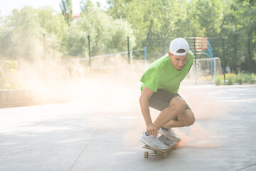 Group of teenagers having fun at the skatepark doing skateboarding and tricks . skaters with colored smoke bombs