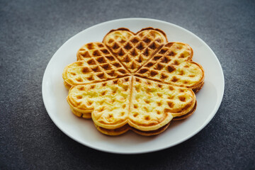 Heart shaped waffles, pancakes. Kids favorite food. Food made with love, Valentine’s Day family breakfast concept.
