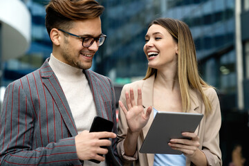 Successful business colleagues people working together on digital devices.