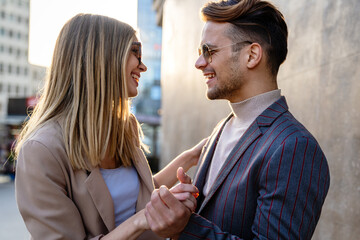 Portrait of romantic happy couple in love hugs and having fun together outdoors. People love concept