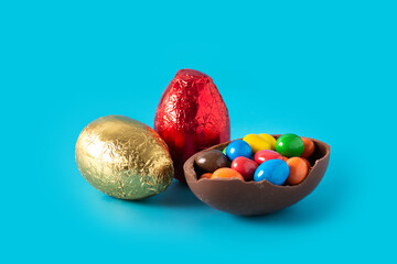 Colorful chocolate Easter eggs on blue bckground
