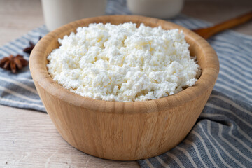 Traditional homemade cottage cheese in a wooden bowl