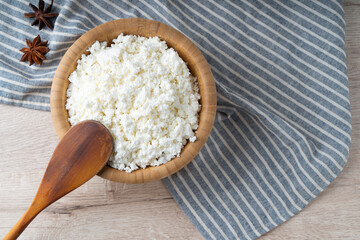 Traditional homemade cottage cheese in a wooden bowl