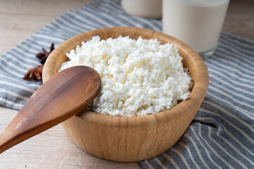Traditional homemade cottage cheese in a wooden bowl