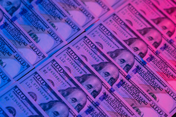 Money background. Dollars lighted by blue and red. Financial market