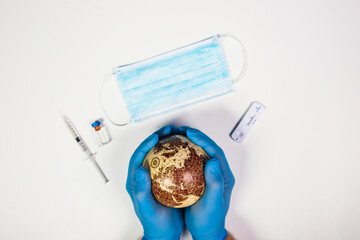 Hands of a doctor holding the planet Earth.