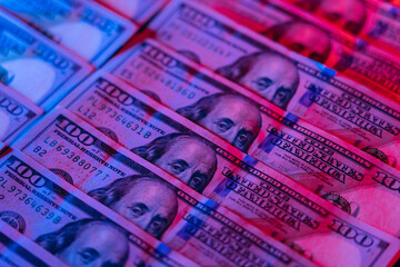 Money background. Dollars lighted by blue and red. Financial market