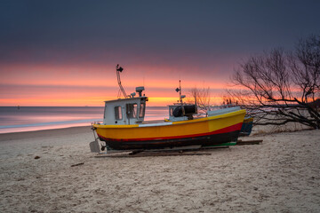 Naklejka na ściany i meble Fishing boats at sunrise on the Baltic Sea beach in Sopot. Poland