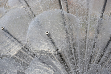 Splashes and drops, water movement abstract figure of a water fountain on blurred background