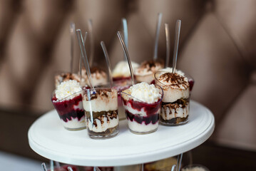 dessert buffet. assortment of sweets. catering service table. desserts garnished with nuts, jellies...
