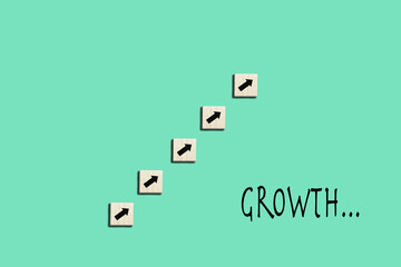 Professional growth concept with wooden cubes with arrows and writing 