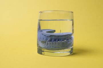 ceramic model of human teeth in a glass