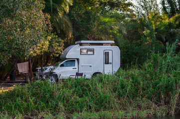 Motorhome on the Okavango riverbank / Camper van stands on the banks of the Okavango River, Namibia, Africa.