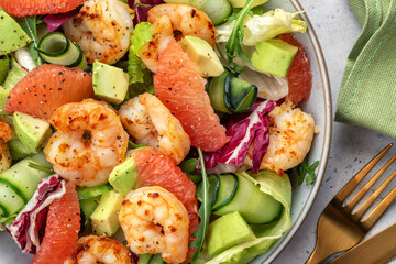 Delicious fresh salad with shrimp prawns, grapefruit, avocado, cucumber and green salad. Healthy food.