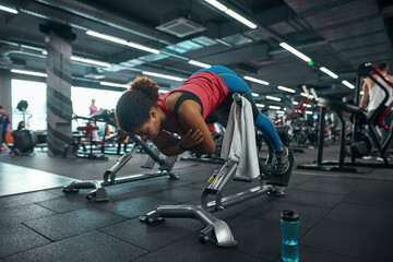 Fototapeta na wymiar Girl do exercise for lumbar on training apparatus